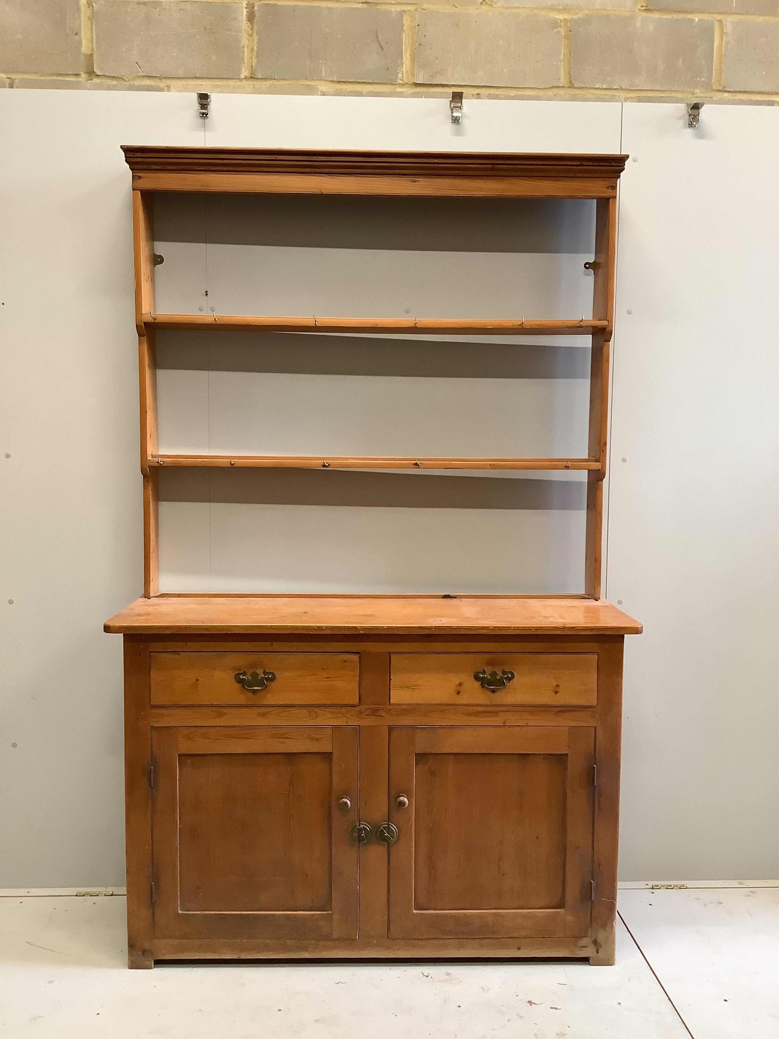 A Victorian pine dresser with open rack, width 137cm, depth 47cm, height 216cm. Condition - fair